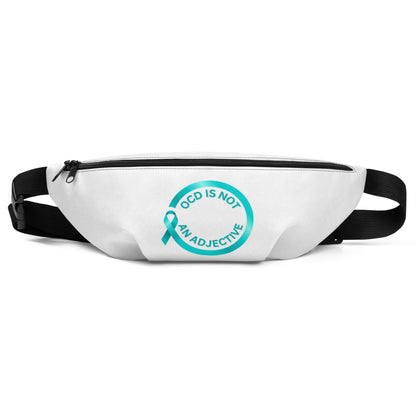 The OCD Is Not An Adjective waist bag by NeuroNiche Design is white with adjustable straps, featuring a teal awareness ribbon and “OCD IS NOT AN ADJECTIVE” in a circular front design.
