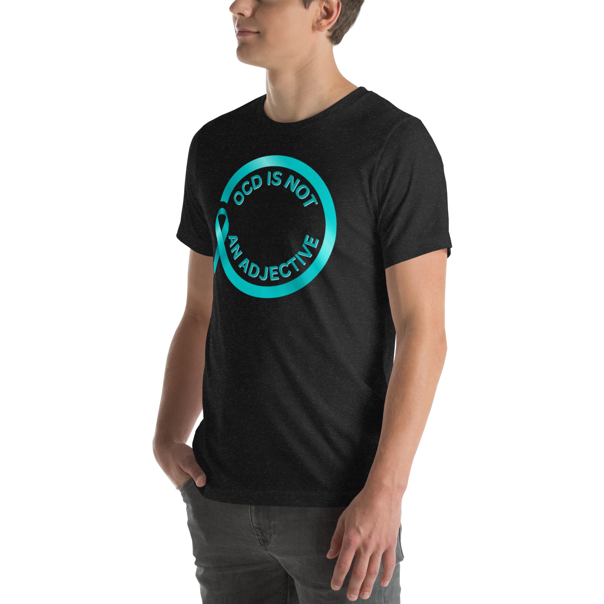 A person wears the NeuroNiche Design "OCD Is Not An Adjective" black combed cotton t-shirt, featuring a blue circle and the statement "OCD IS NOT AN ADJECTIVE" on the front, standing with one hand in their pocket.