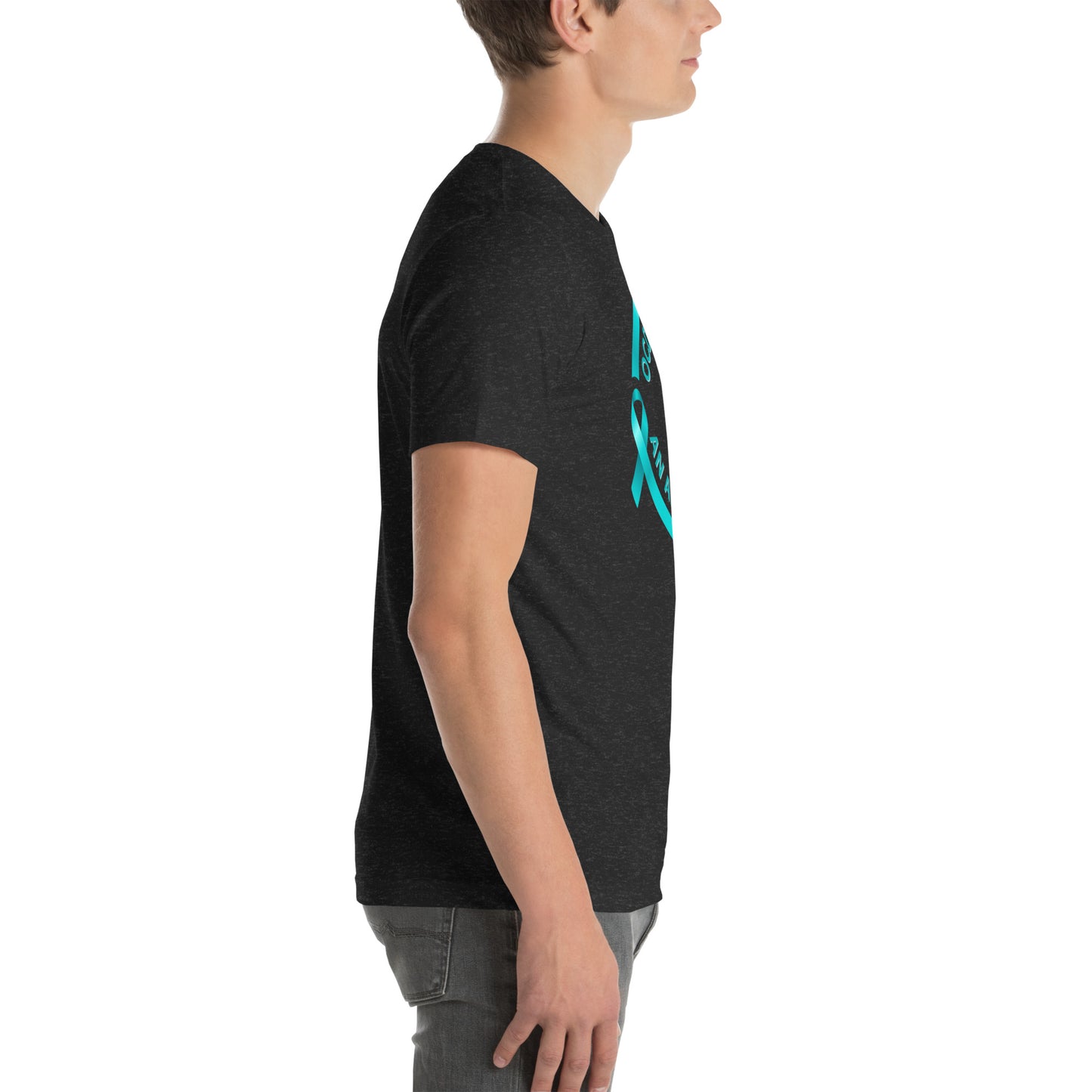A young man in profile wears the NeuroNiche Design "OCD Is Not An Adjective" black combed cotton t-shirt featuring a blue awareness ribbon and front text, paired with gray jeans. The image highlights his upper body and side view.