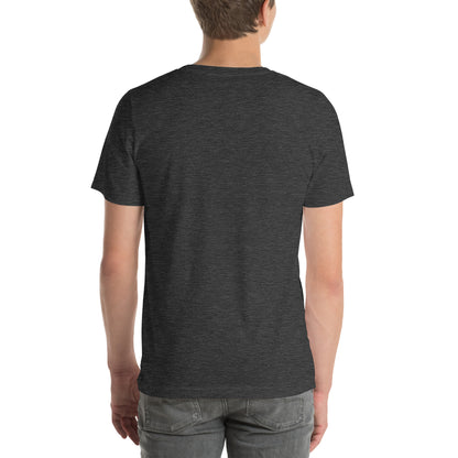 A person with their back to the camera wears a NeuroNiche Design "OCD Is Not An Adjective" t-shirt in plain dark gray combed cotton and light gray jeans. The background is white and uncluttered.