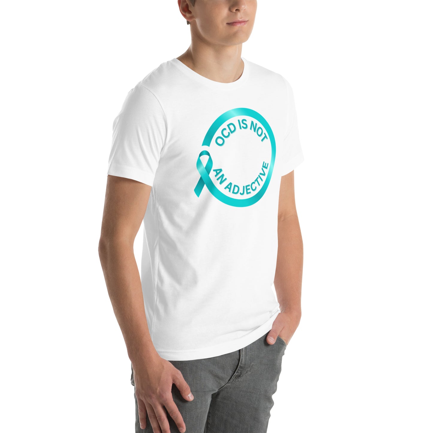 Someone stands with hands in their pockets wearing NeuroNiche Design’s "OCD Is Not An Adjective" white combed cotton t-shirt, featuring a teal awareness ribbon and the phrase inside a teal circle.